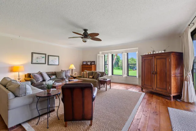 a living room with furniture a window and a flat screen tv