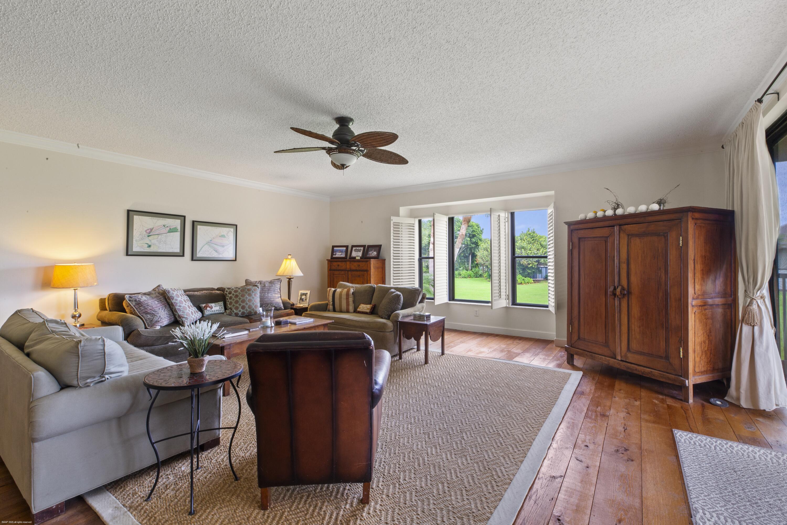 13244 Polo Club Road, Unit C206 Wellington, FL 33414 - Photo 4 of 46 a living room with furniture a window and a flat screen tv