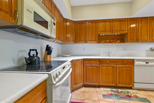 a kitchen with stainless steel appliances granite countertop a sink and cabinets