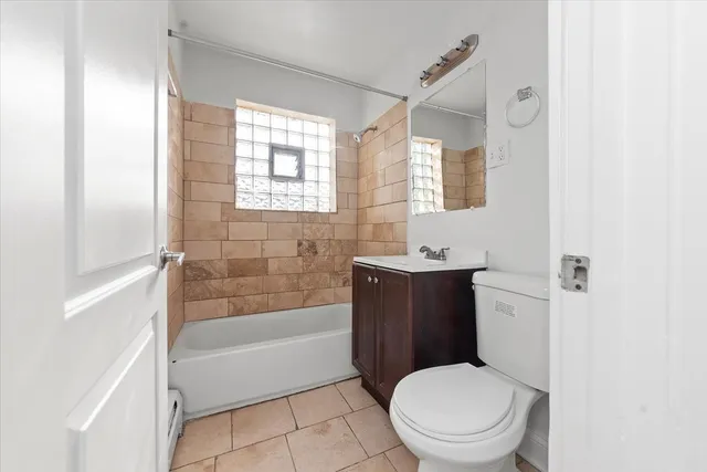 a bathroom with a toilet a sink and bathtub