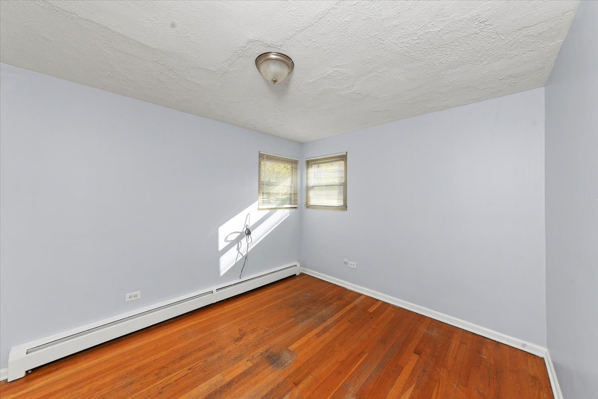 335 Custer Avenue, Unit 2S Evanston, IL 60202 - Photo 5 of 10 a view of empty room with wooden floor and fan