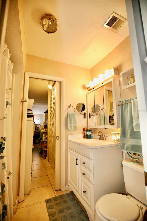 679 Melanie Lane Altamonte Springs, FL 32701 - Photo 13 of 23 a bathroom with a toilet sink and mirror