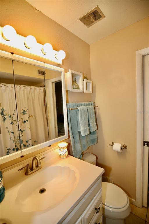 679 Melanie Lane Altamonte Springs, FL 32701 - Photo 14 of 23 a bathroom with a sink mirror vanity and toilet