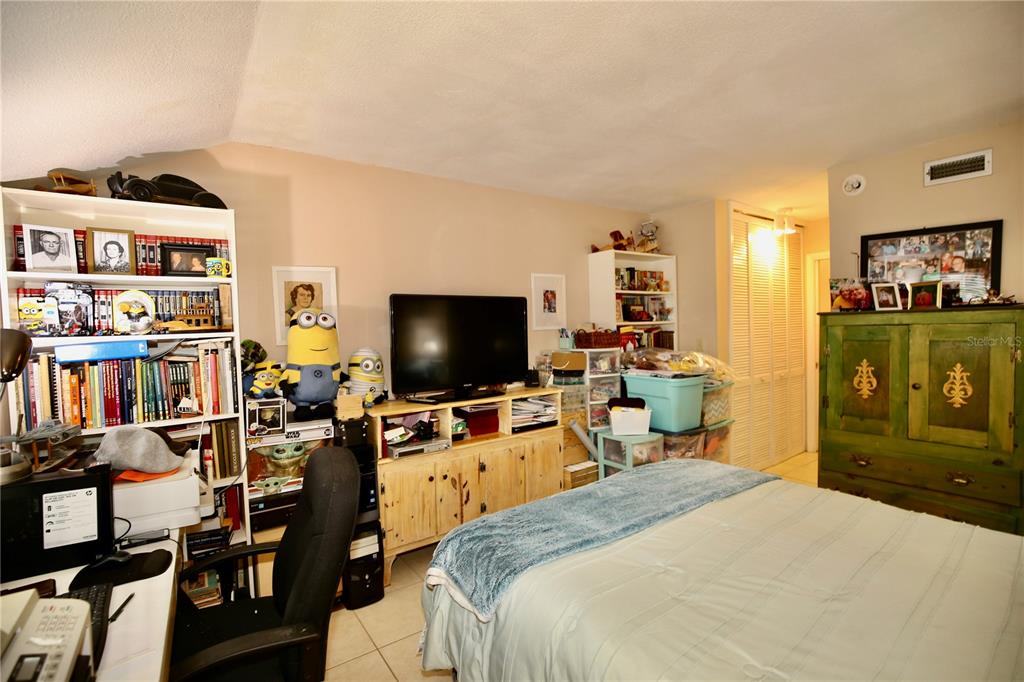 679 Melanie Lane Altamonte Springs, FL 32701 - Photo 16 of 23 a bedroom with a bed and a television