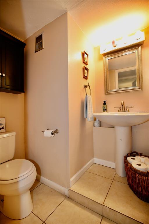 679 Melanie Lane Altamonte Springs, FL 32701 - Photo 19 of 23 a bathroom with a sink toilet and mirror