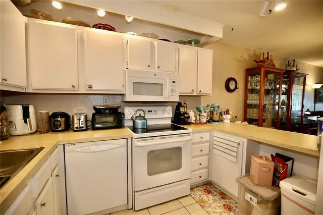 a living room with couches a dining table and chairs with outer view