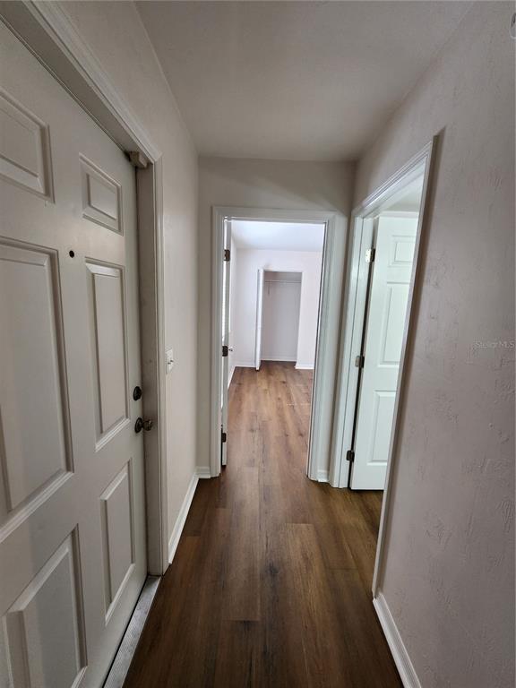 5823 Southwest 9th Place, Unit H55 Gainesville, FL 32607 - Photo 12 of 50 a view of a hallway with wooden floor and staircase