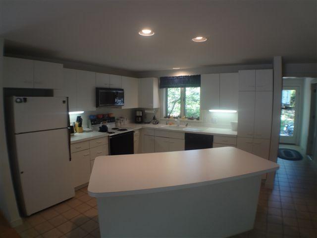 111 Fells Pond Road Mashpee, MA 02649 - Photo 2 of 15 a kitchen with a refrigerator a stove top oven a sink and cabinets
