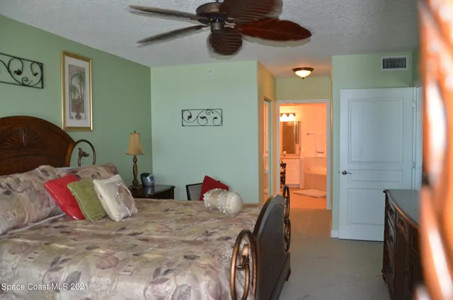 a bedroom with a bed dresser and a window