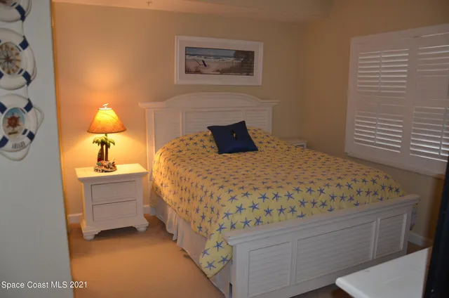 a bedroom with a bed and a lamp