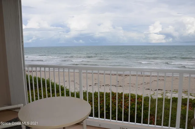 a view of a balcony with wooden floor