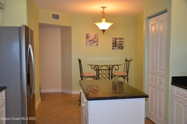 a view of a dining room with furniture and a chandelier