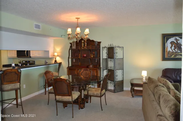a view of a dining room with furniture and chandelier