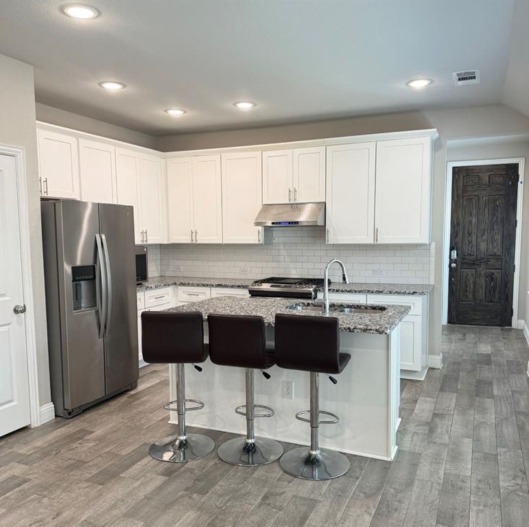 1659 Timpson Drive Forney, TX 75126 - Photo 5 of 10 a kitchen with stainless steel appliances granite countertop a refrigerator and a stove top oven