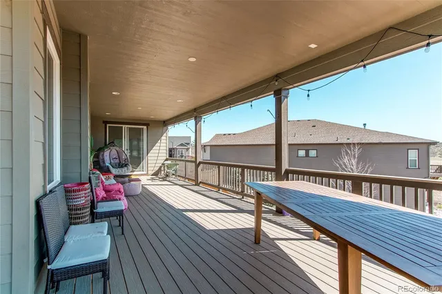 a sitting area with furniture on wooden deck