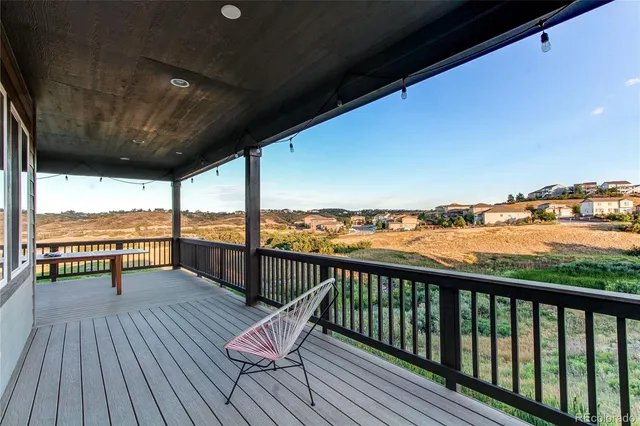 a view of a balcony with wooden floor