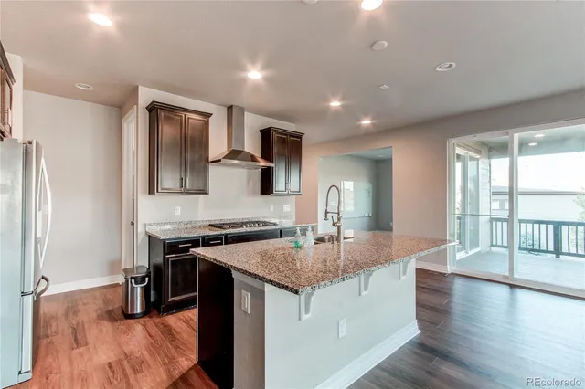 a large kitchen with stainless steel appliances granite countertop a stove and a sink