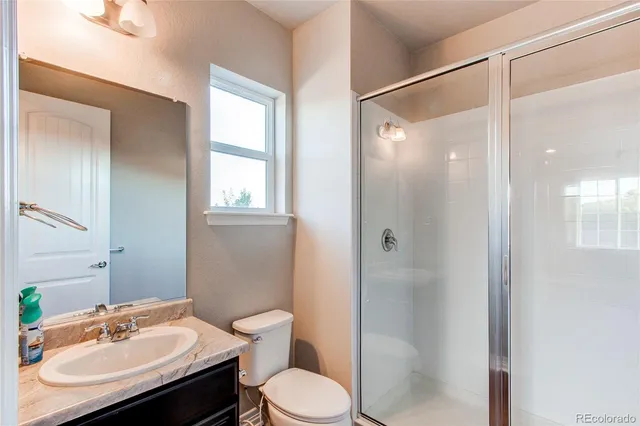 a bathroom with a tub double vanity sink and a large mirror