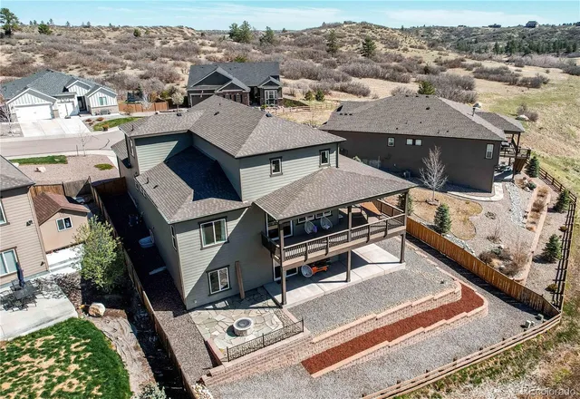 an aerial view of a house with a yard