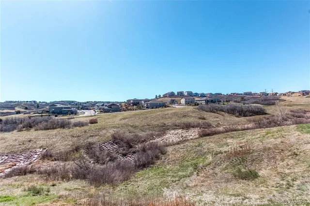 a view of a lake and green valley