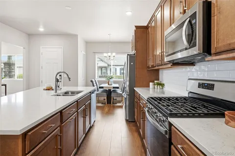 a kitchen with sink stove and cabinets