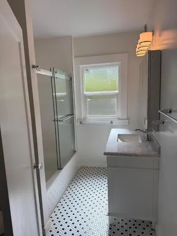 a bathroom with a sink a toilet and a mirror
