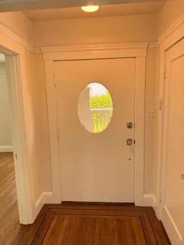 a view of front door with wooden floor
