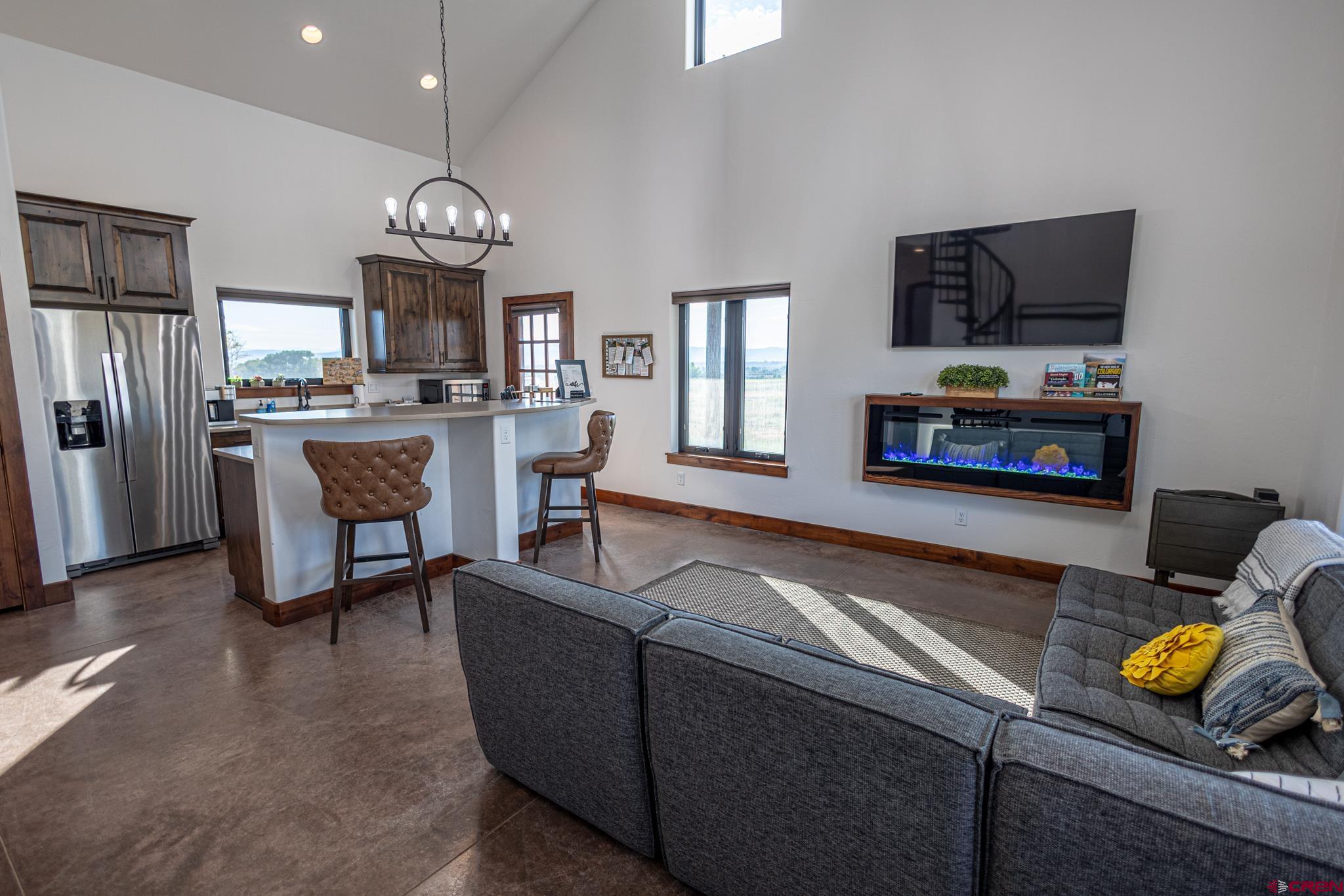 53582 Falcon Road Olathe, CO 81425 - Photo 32 of 35 a living room with fireplace furniture and a flat screen tv