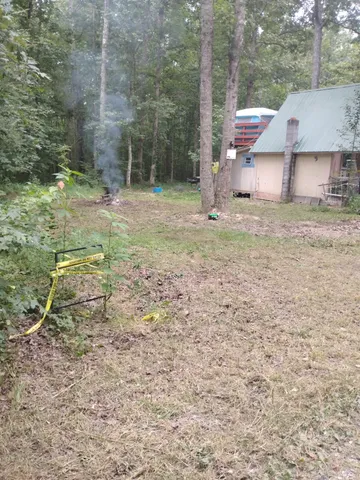 a backyard of a house with table and chairs