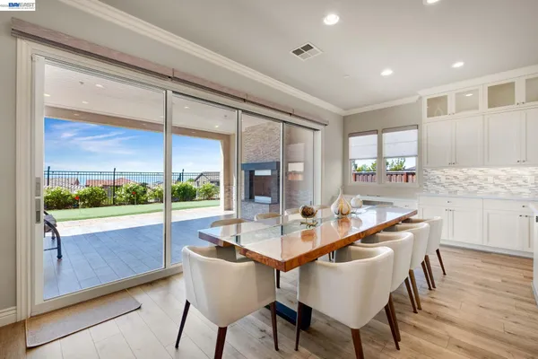 a living room with furniture and a table with wooden floor