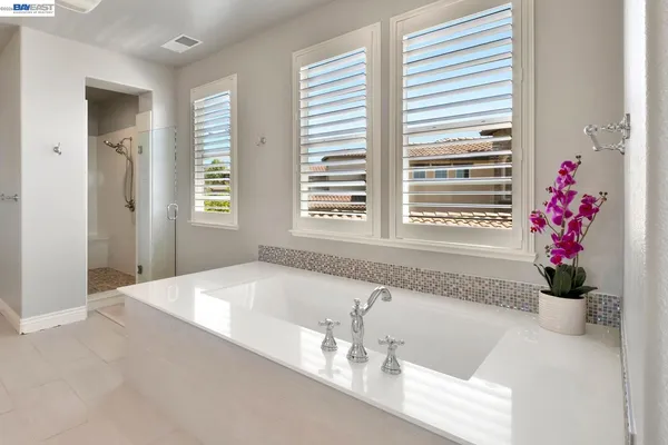 a view of a livingroom with wooden floor and a fireplace
