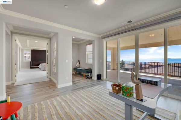 a view of a room with wooden floor and windows