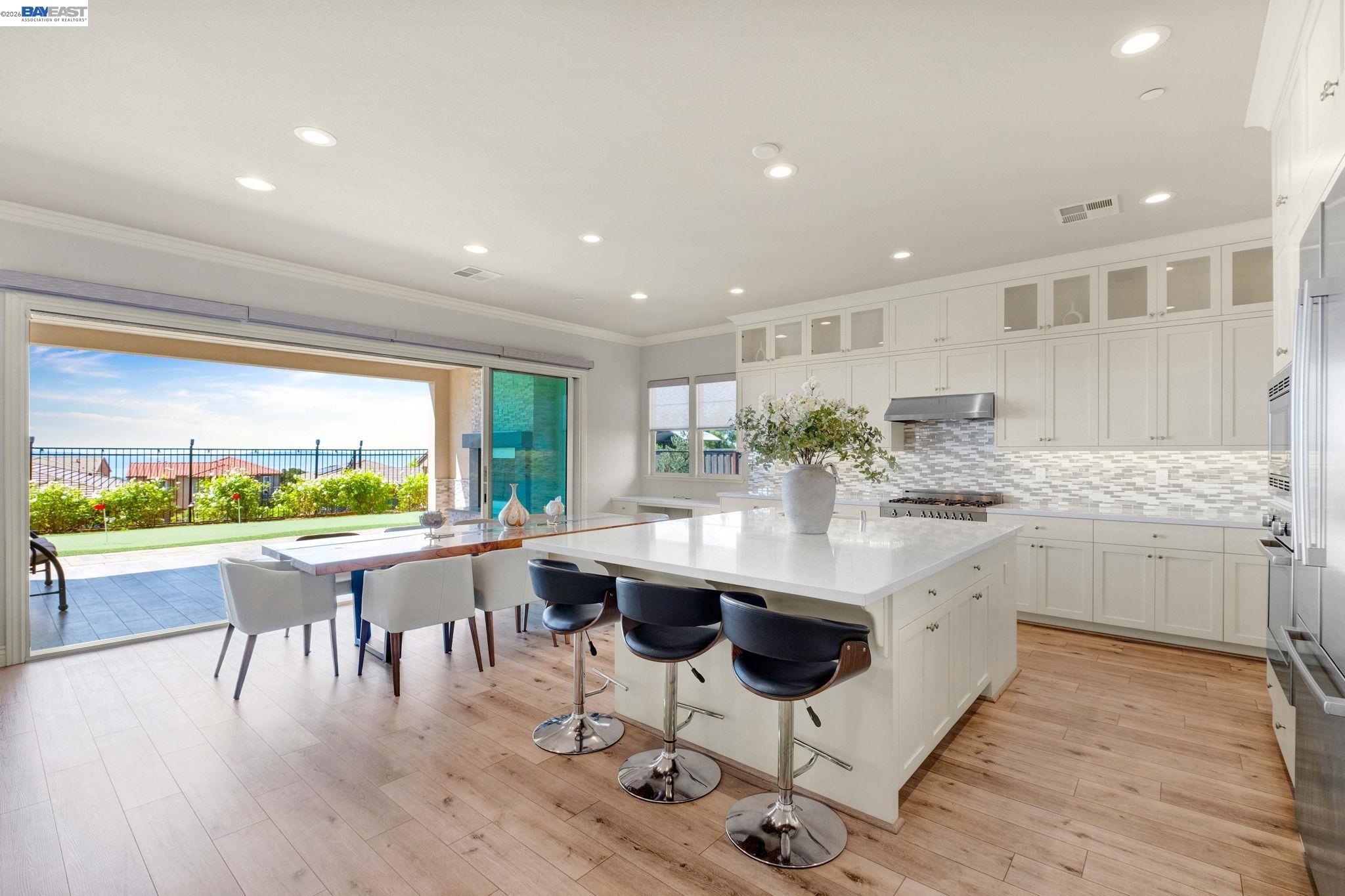 128 Dunfirth Drive Hayward, CA 94542 - Photo 6 of 60 a kitchen with a table chairs wooden floor and appliances