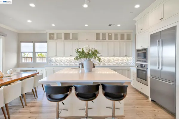 a view of a porch with a potted plant and floor to ceiling window