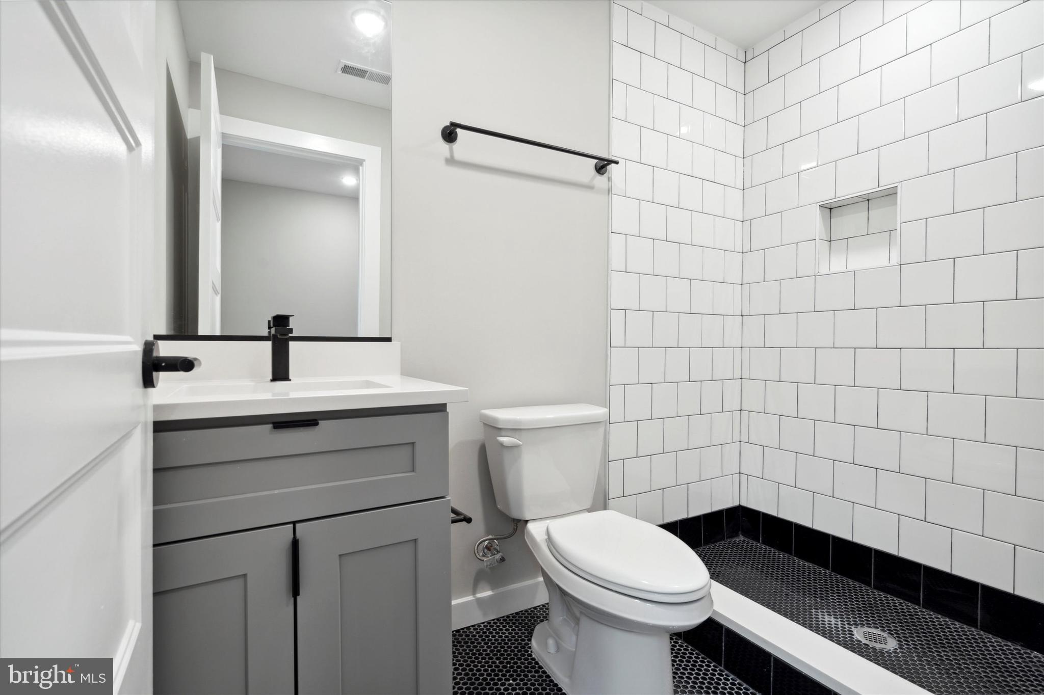 3519 Hamilton Street, Unit B Philadelphia, PA 19104 - Photo 13 of 16 a bathroom with a sink toilet and shower