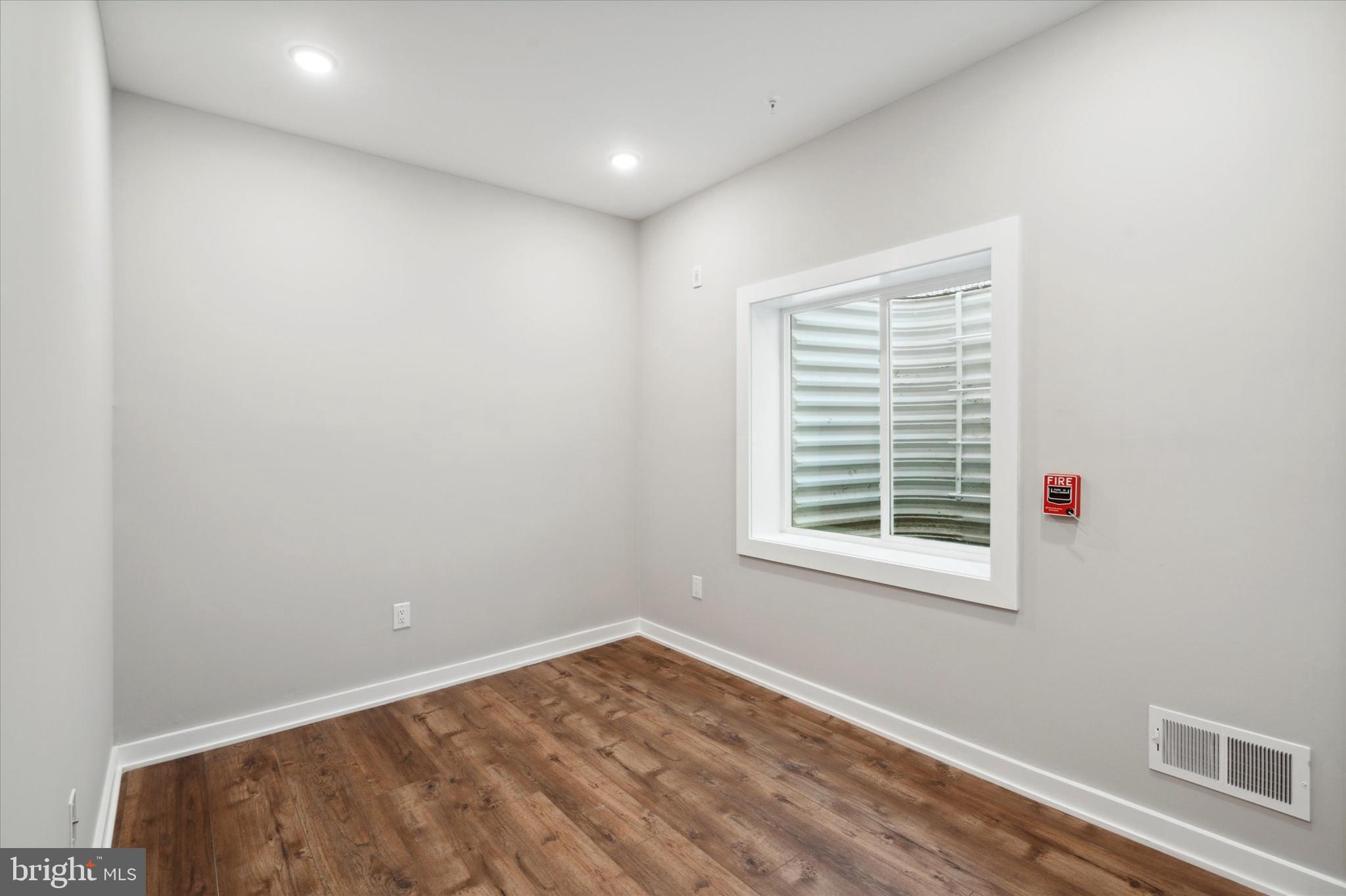 3519 Hamilton Street, Unit B Philadelphia, PA 19104 - Photo 14 of 16 a view of an empty room with wooden floor and a window