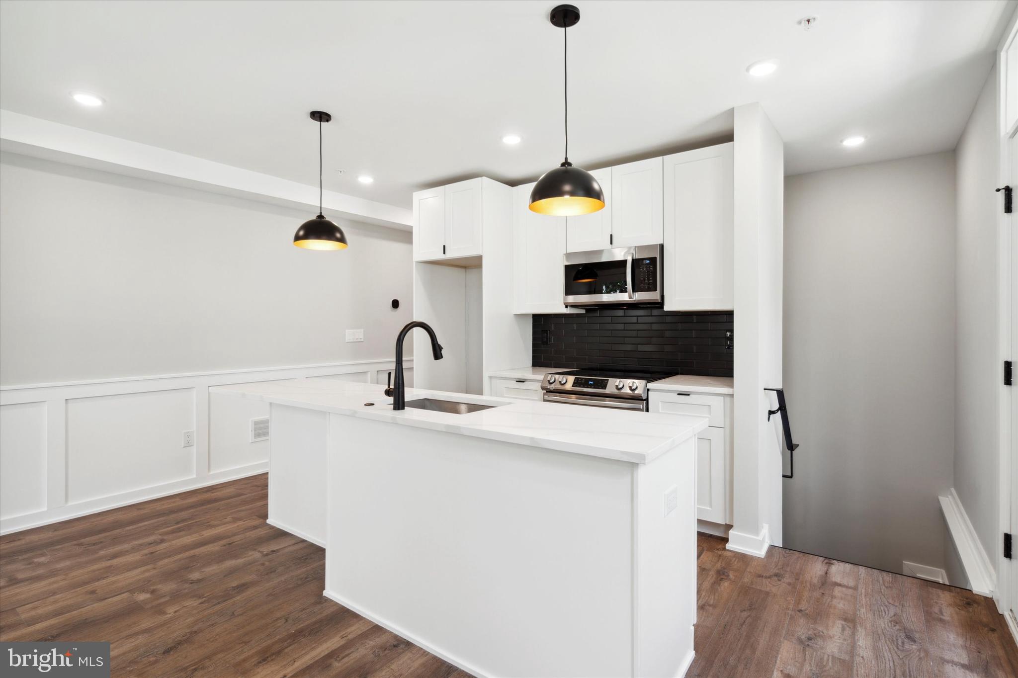 3519 Hamilton Street, Unit B Philadelphia, PA 19104 - Photo 5 of 16 a view of a kitchen with a sink wooden floor and a chandelier