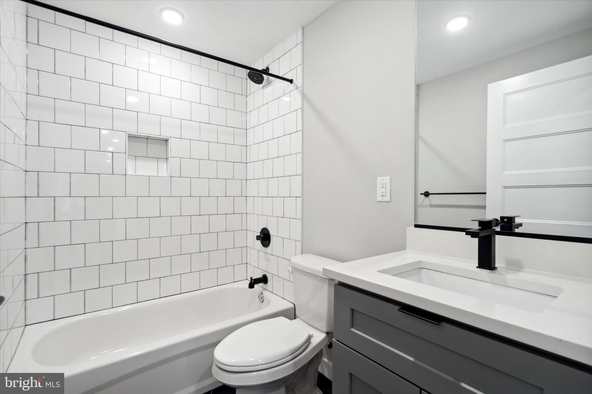 3519 Hamilton Street, Unit B Philadelphia, PA 19104 - Photo 10 of 16 a bathroom with a sink a toilet and shower