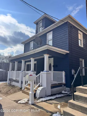 a front view of a house with stairs