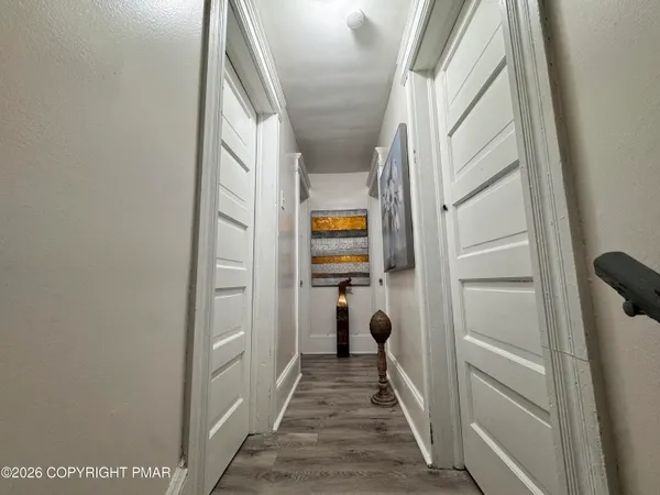 a view of hallway with wooden floor and staircase