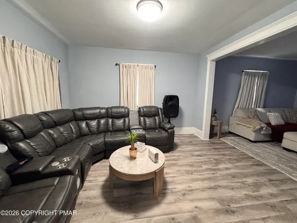 a living room with furniture a couch and large window