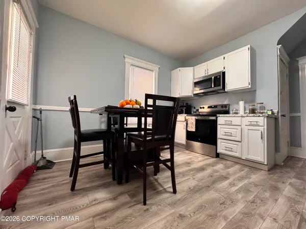 a view of a dining room with furniture and wooden floor