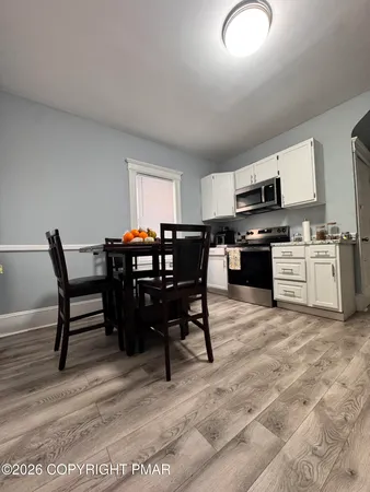 a view of a dining room with furniture and a kitchen