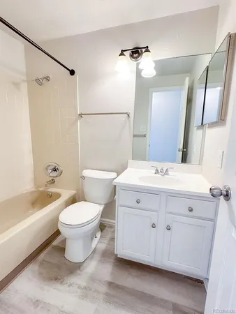 a bathroom with a sink a toilet and bathtub