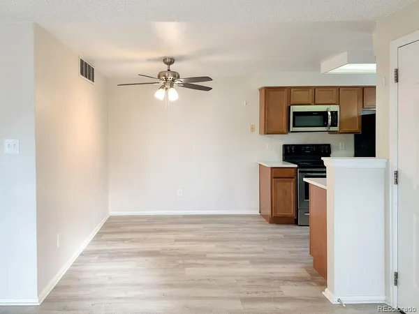 a view of kitchen with microwave and cabinets