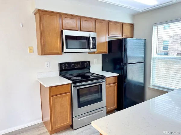 a kitchen with a stove microwave and refrigerator