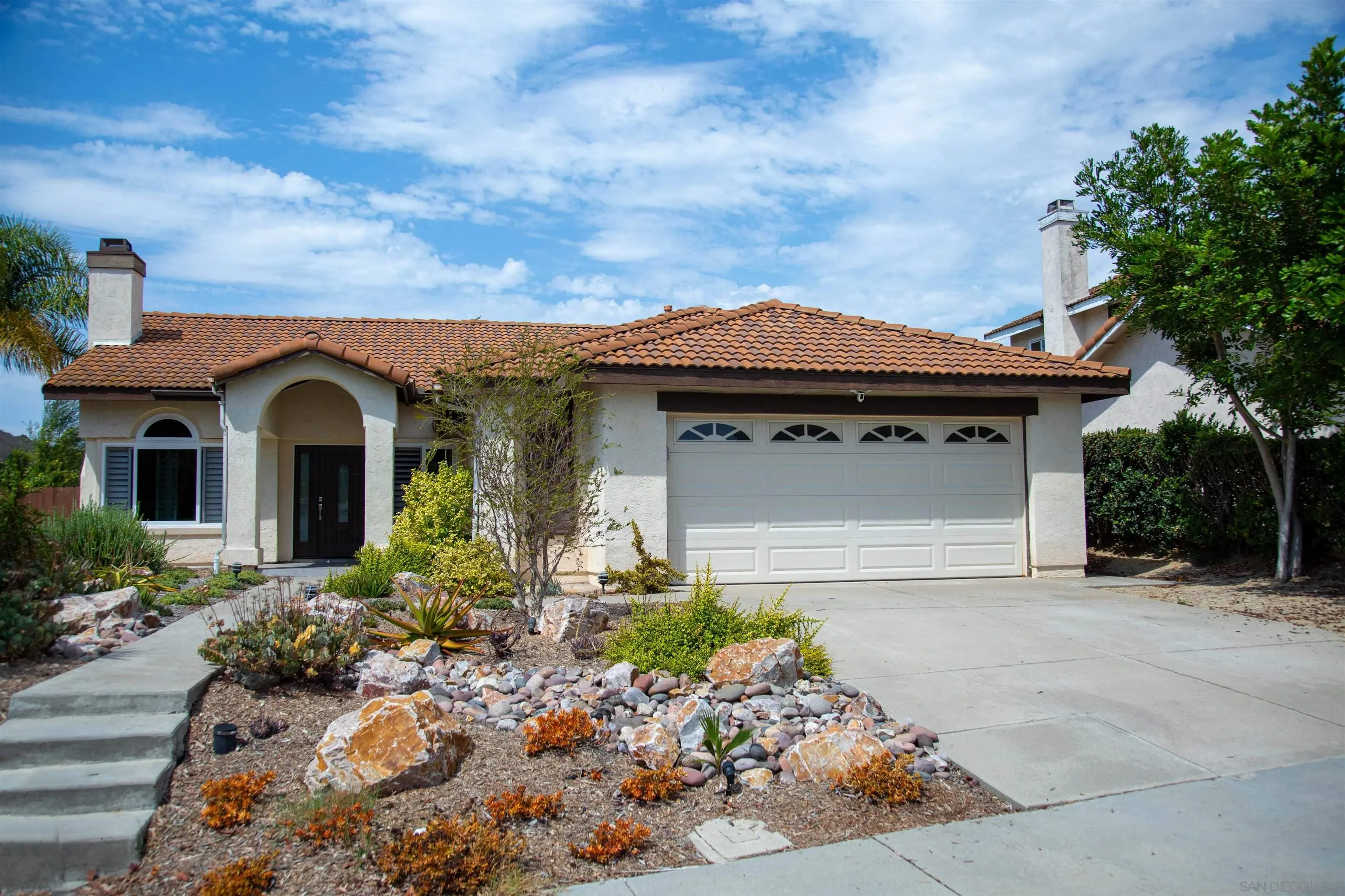 9182 Emden Road San Diego, CA 92129 - Photo 1 of 27 a front view of a house with a garden