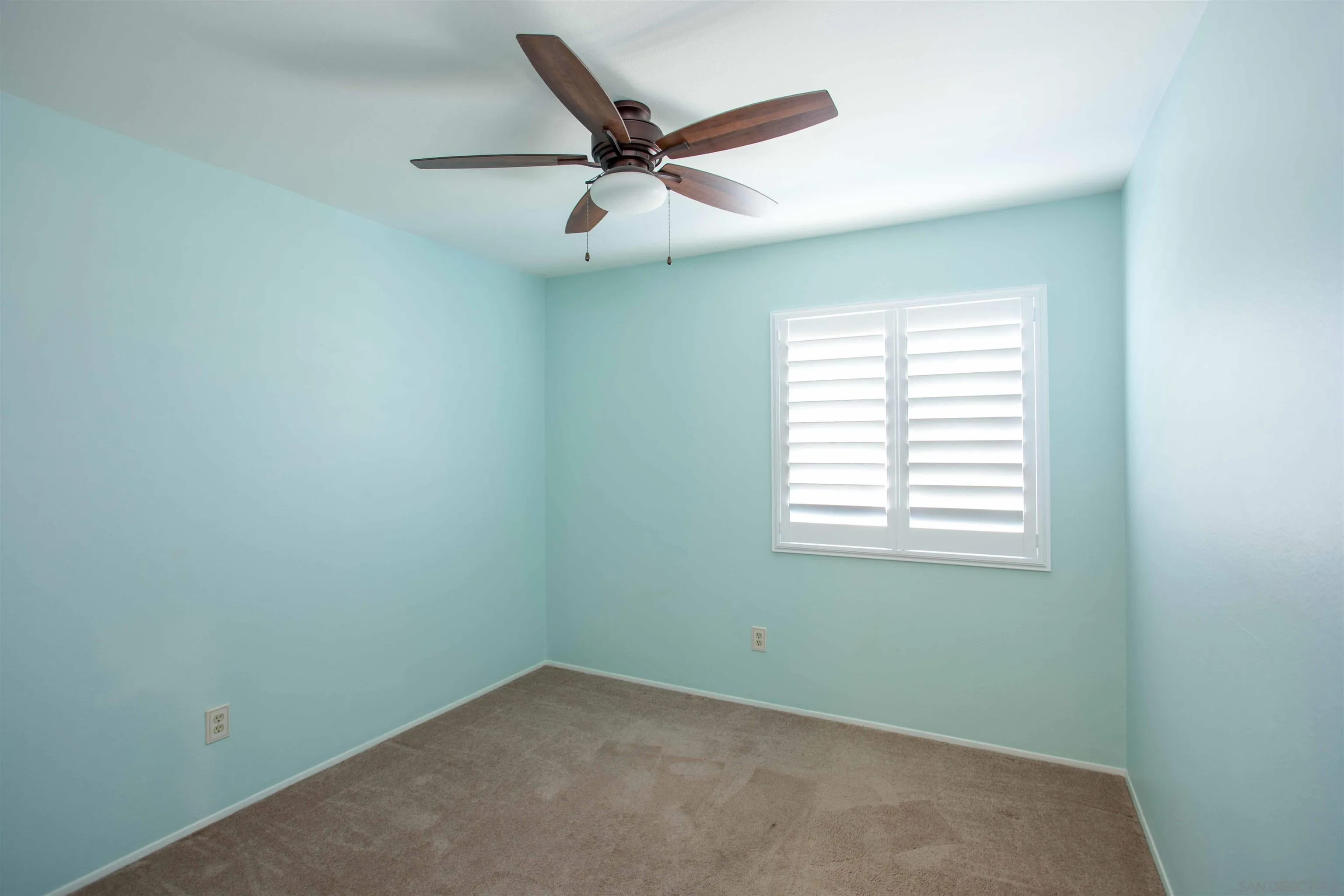 9182 Emden Road San Diego, CA 92129 - Photo 16 of 27 an empty room with a ceiling fan and windows