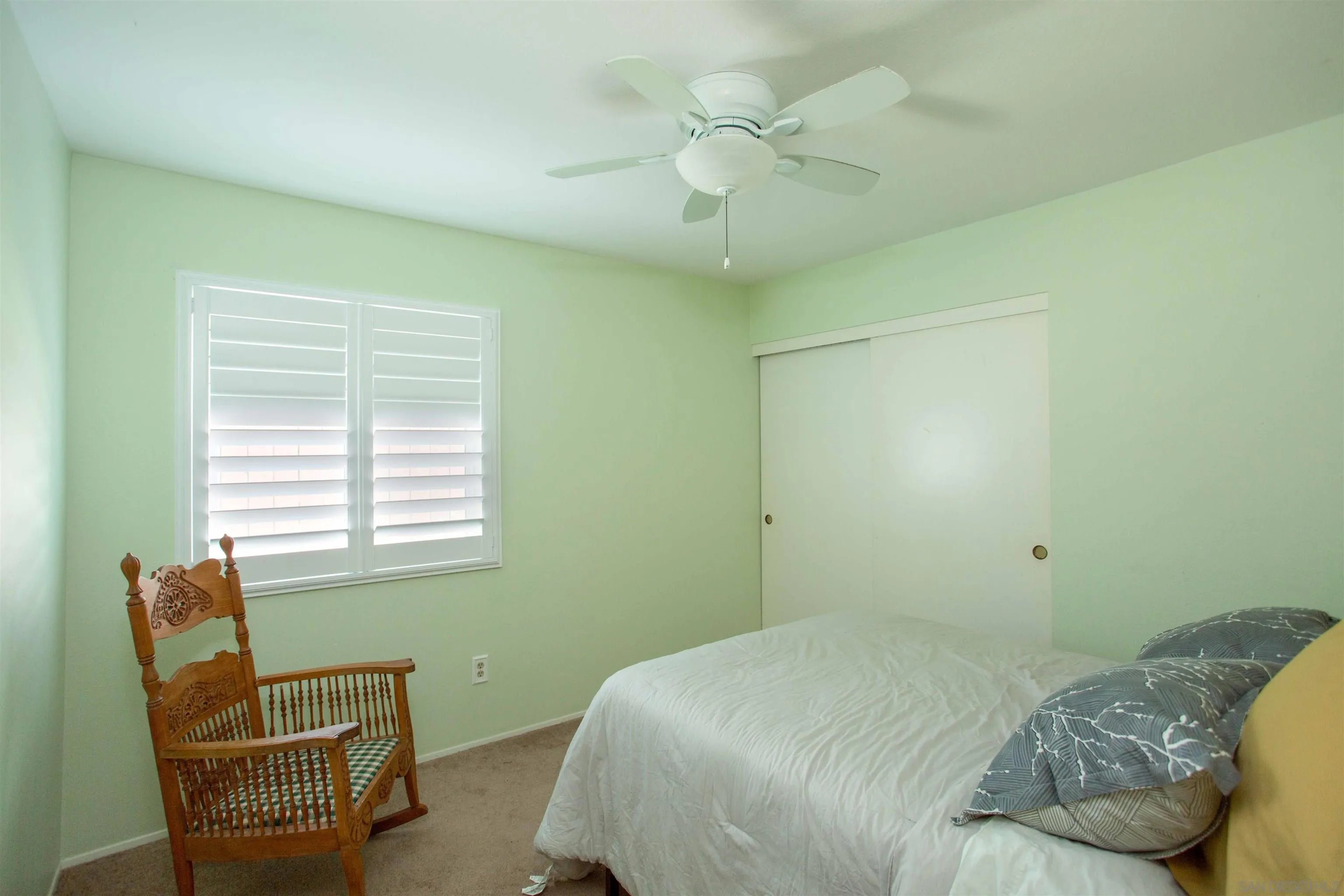 9182 Emden Road San Diego, CA 92129 - Photo 17 of 27 a bedroom with a bed and a chair