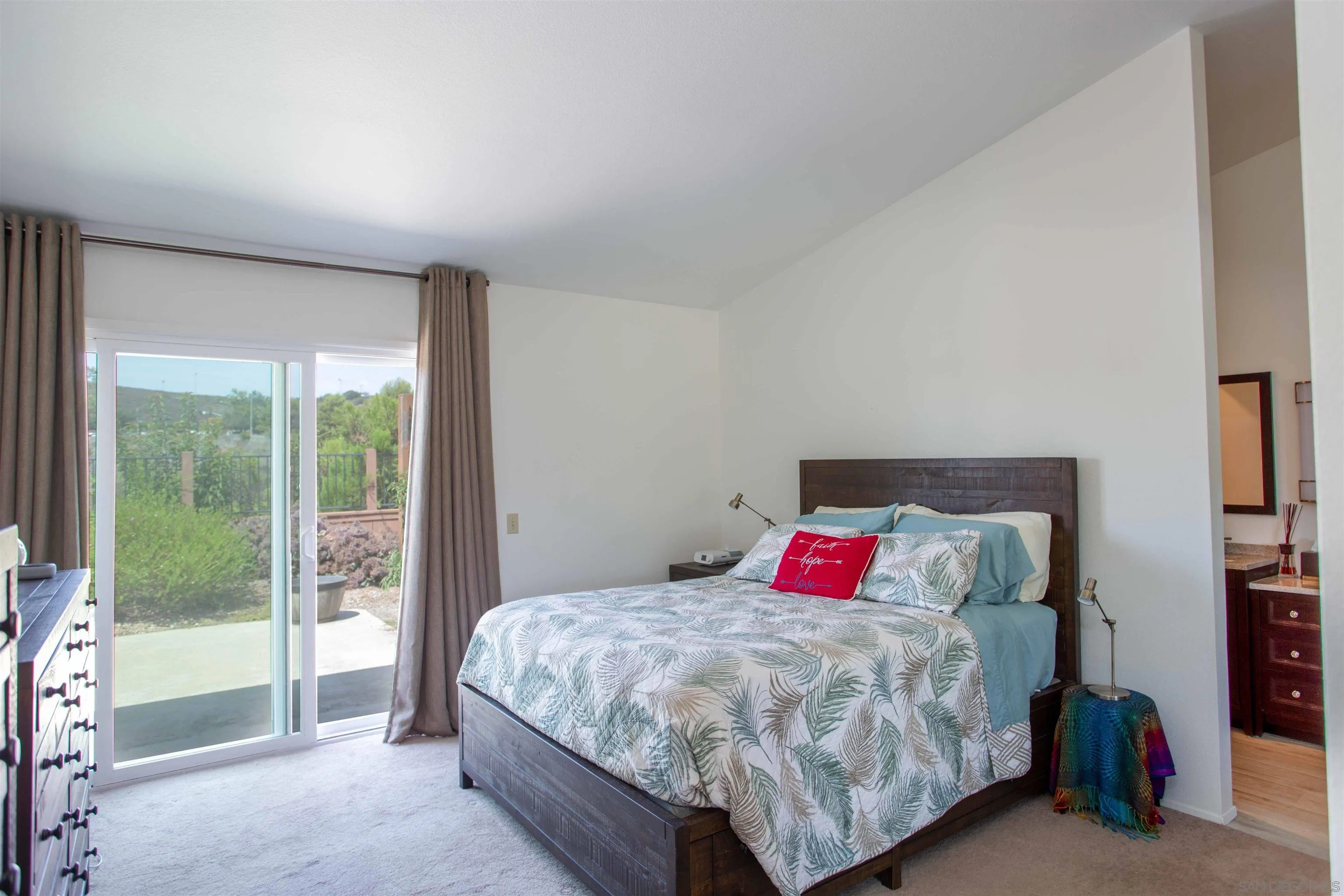 9182 Emden Road San Diego, CA 92129 - Photo 18 of 27 a bedroom with a large bed and a large window